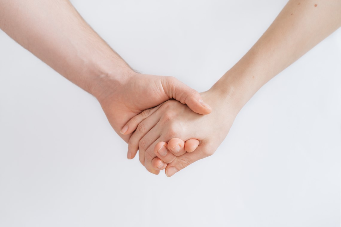 Two people holdings hands