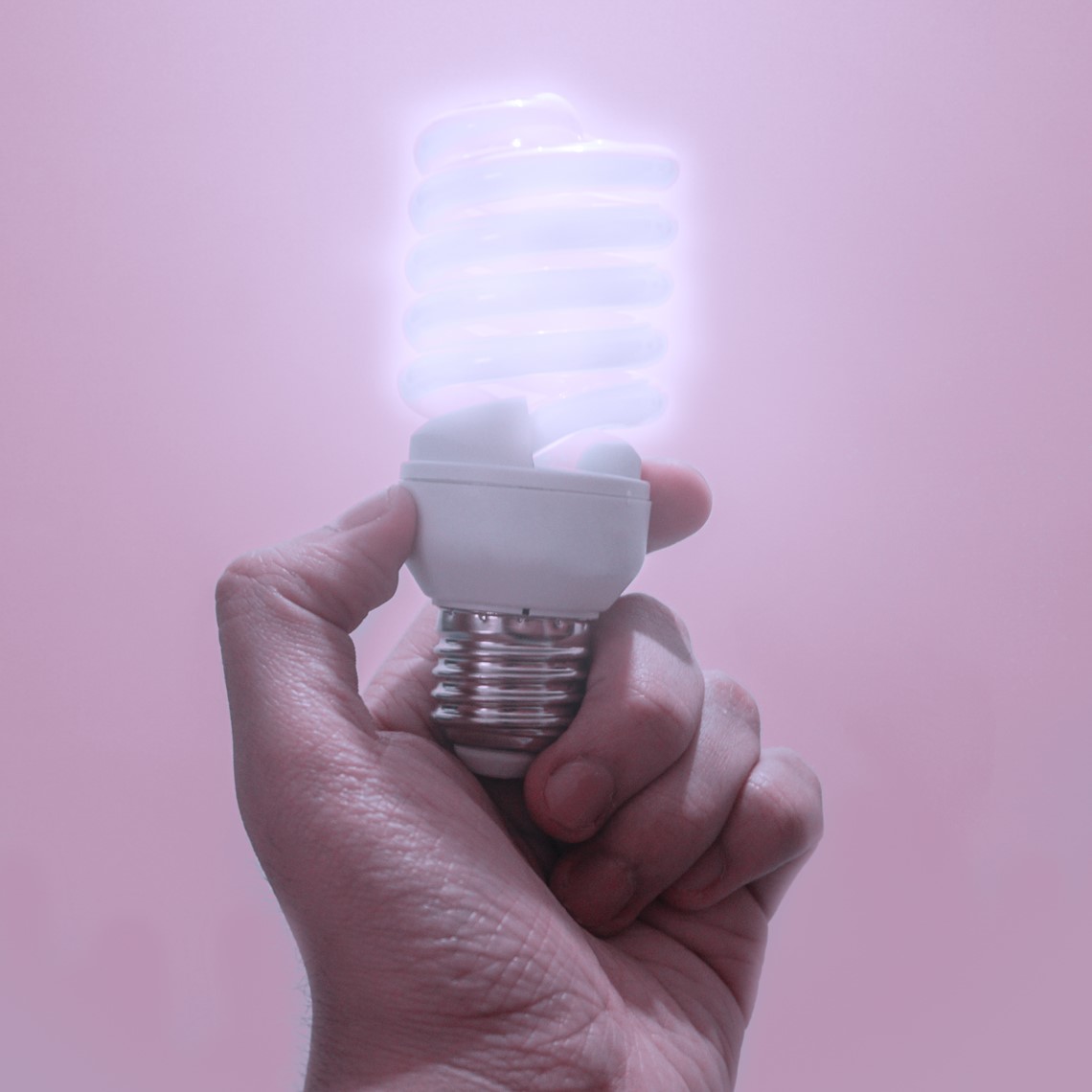 hand holding a light bulb