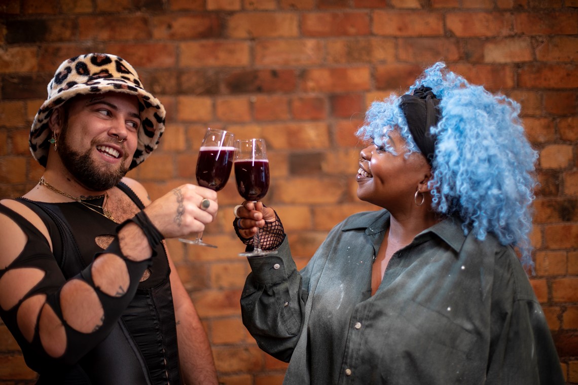 People at a party, cheering their wine glasses