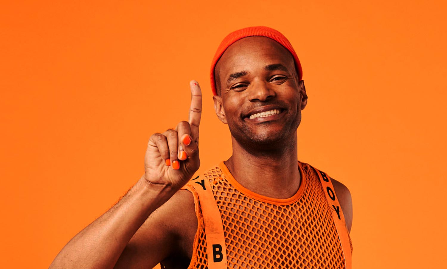 Person in an orange outfit raising their index finger