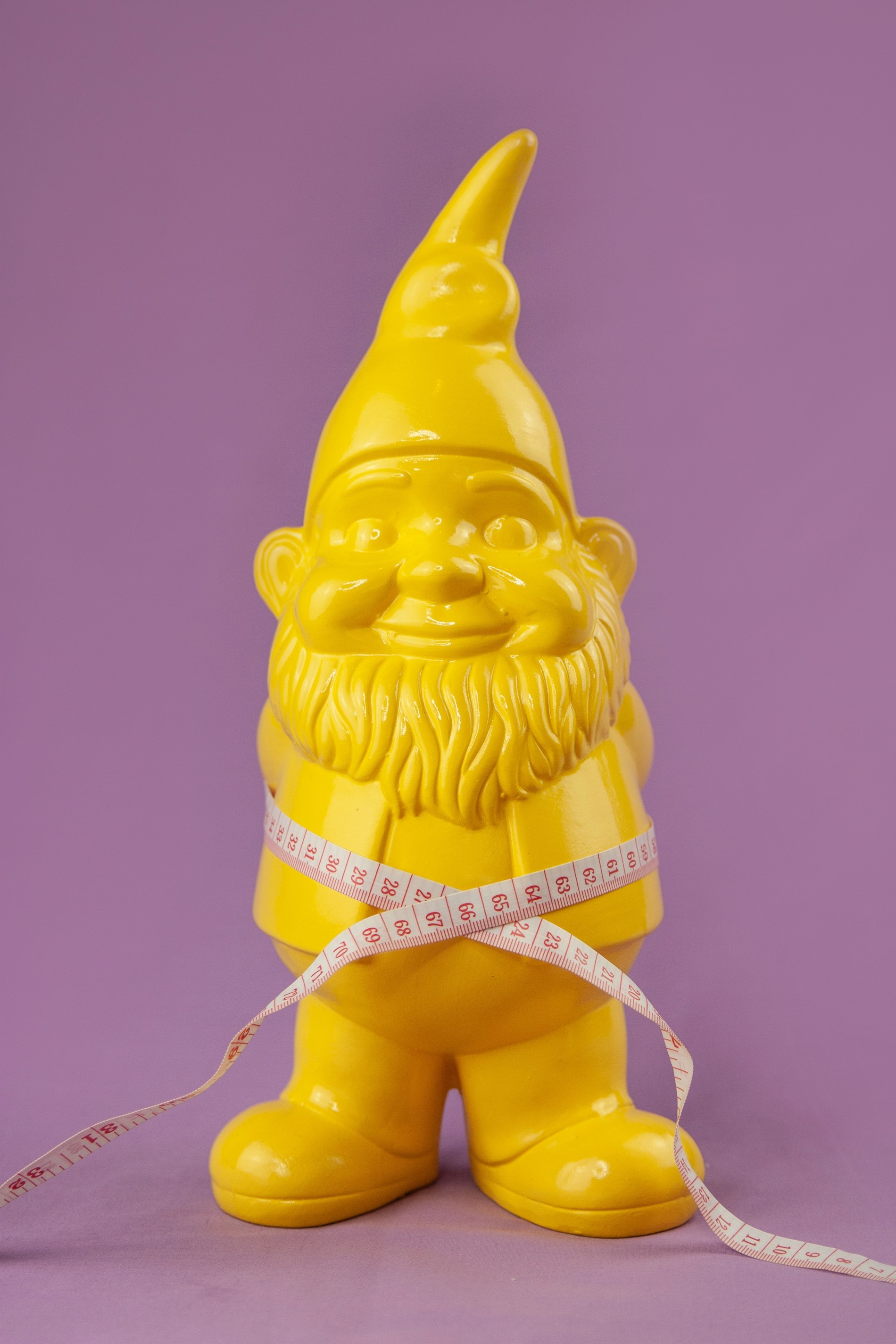 A gnome with measuring tape around it