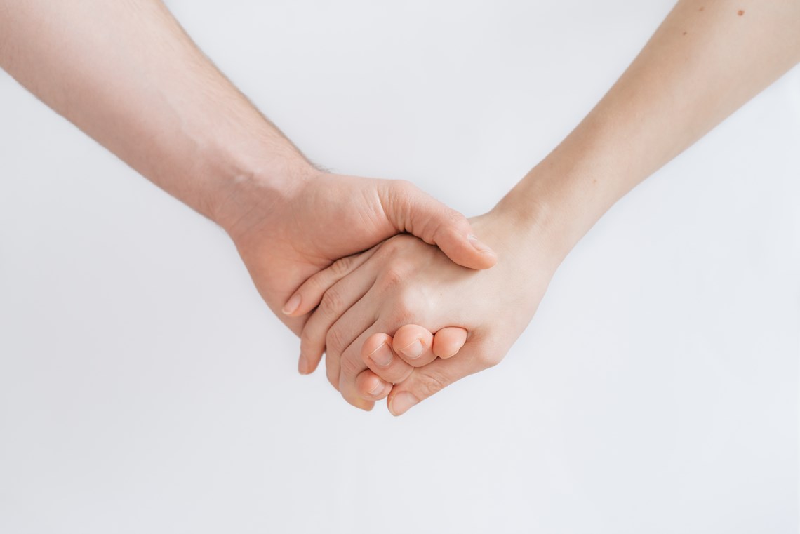 Two people holdings hands