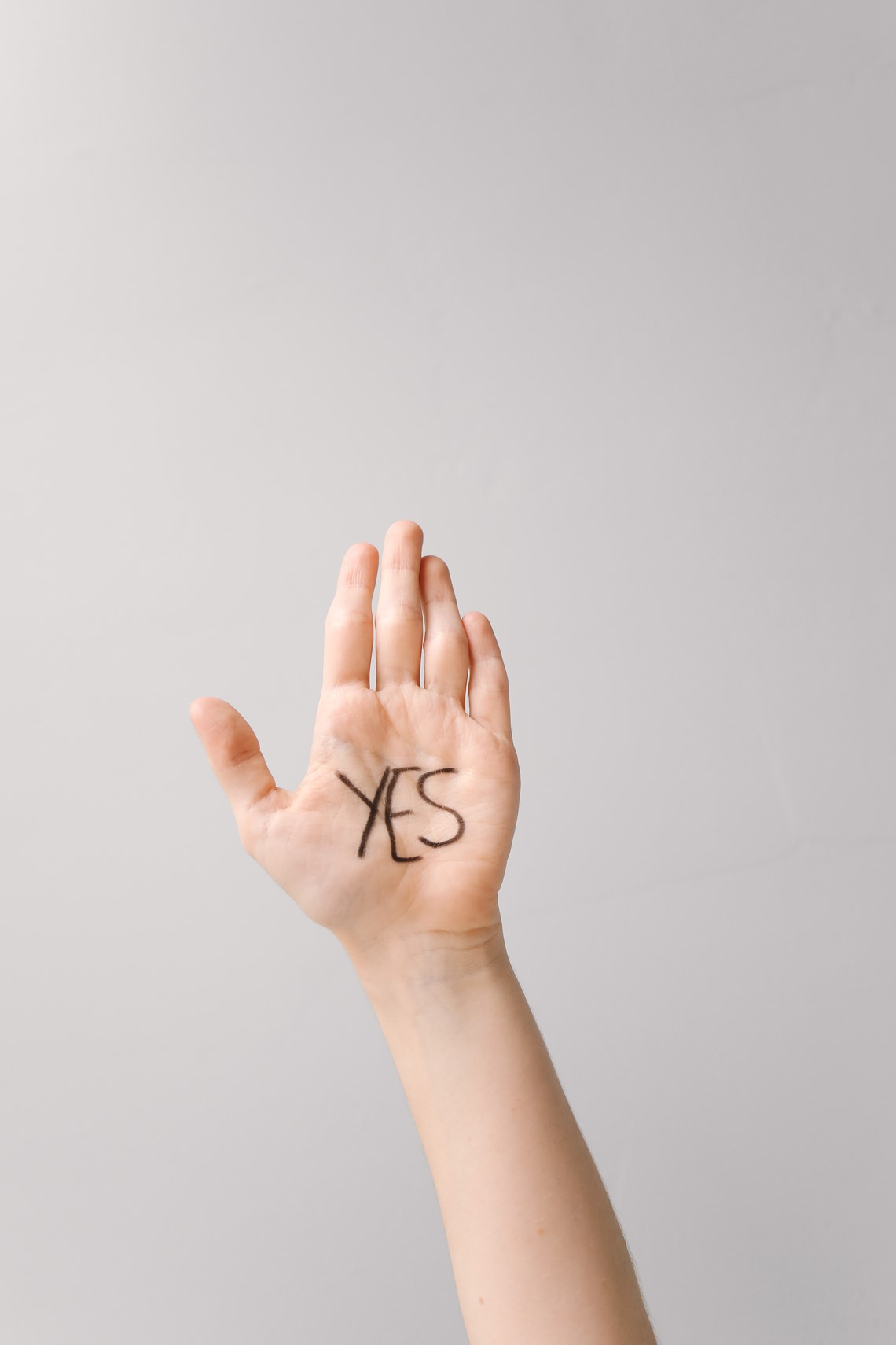 Raised hand saying yes on their palm
