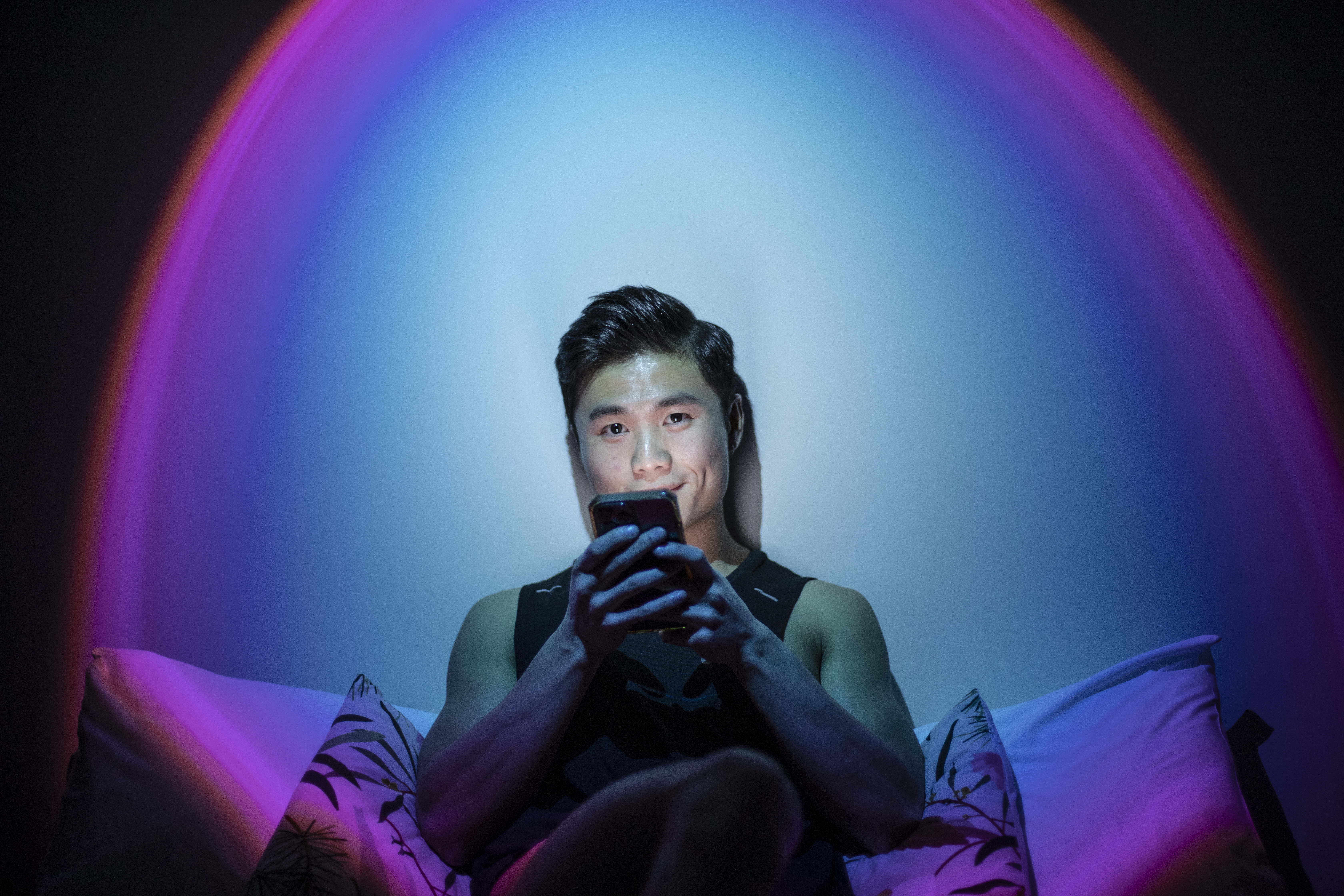 Person on their bed looking at their phone