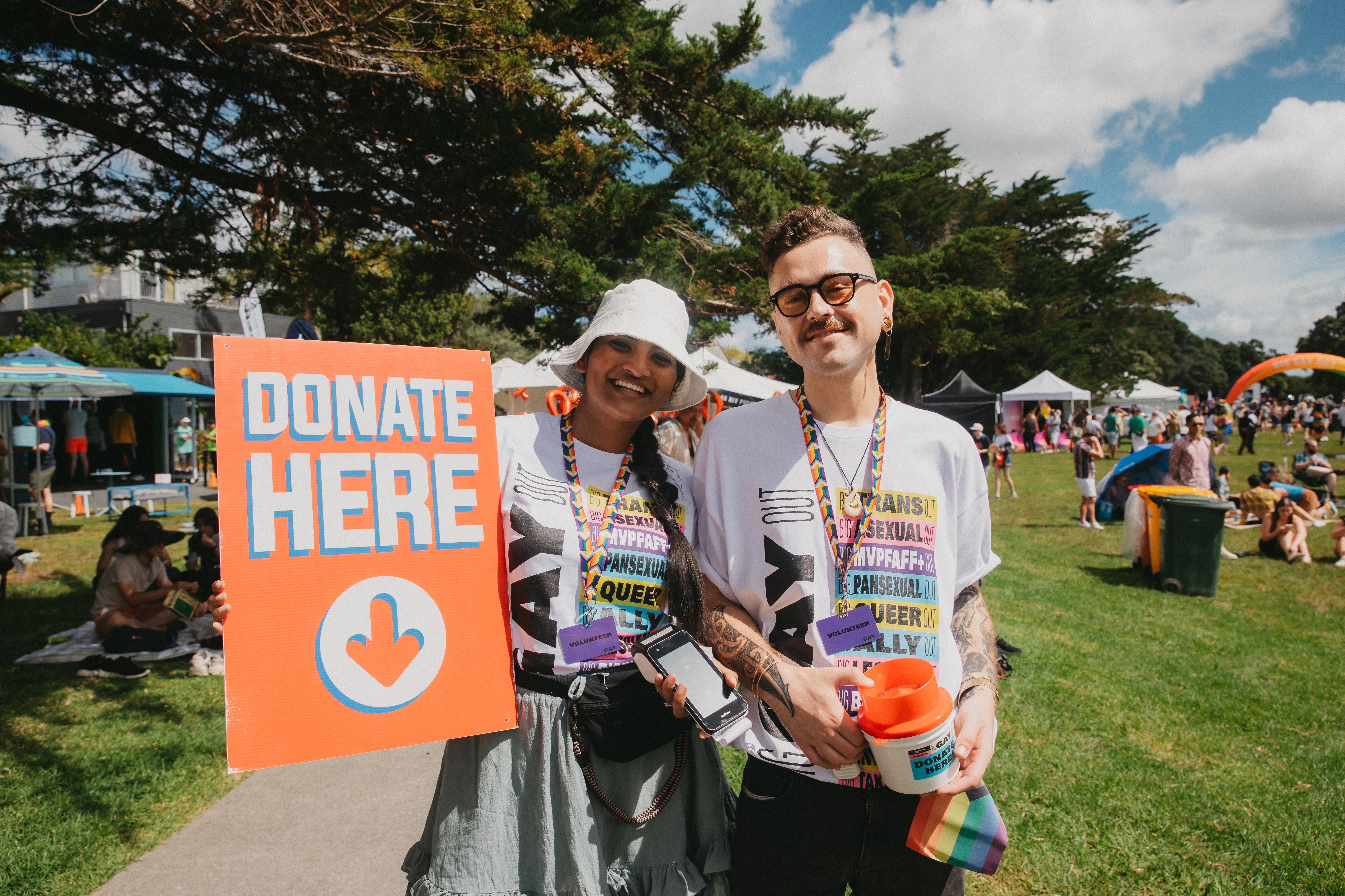 Volunteers at the BGO holding "Donate here" sign
