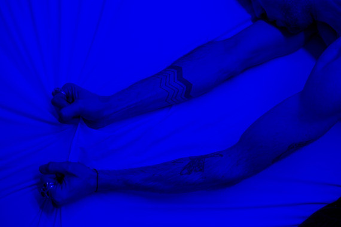 Person gripping bed sheets