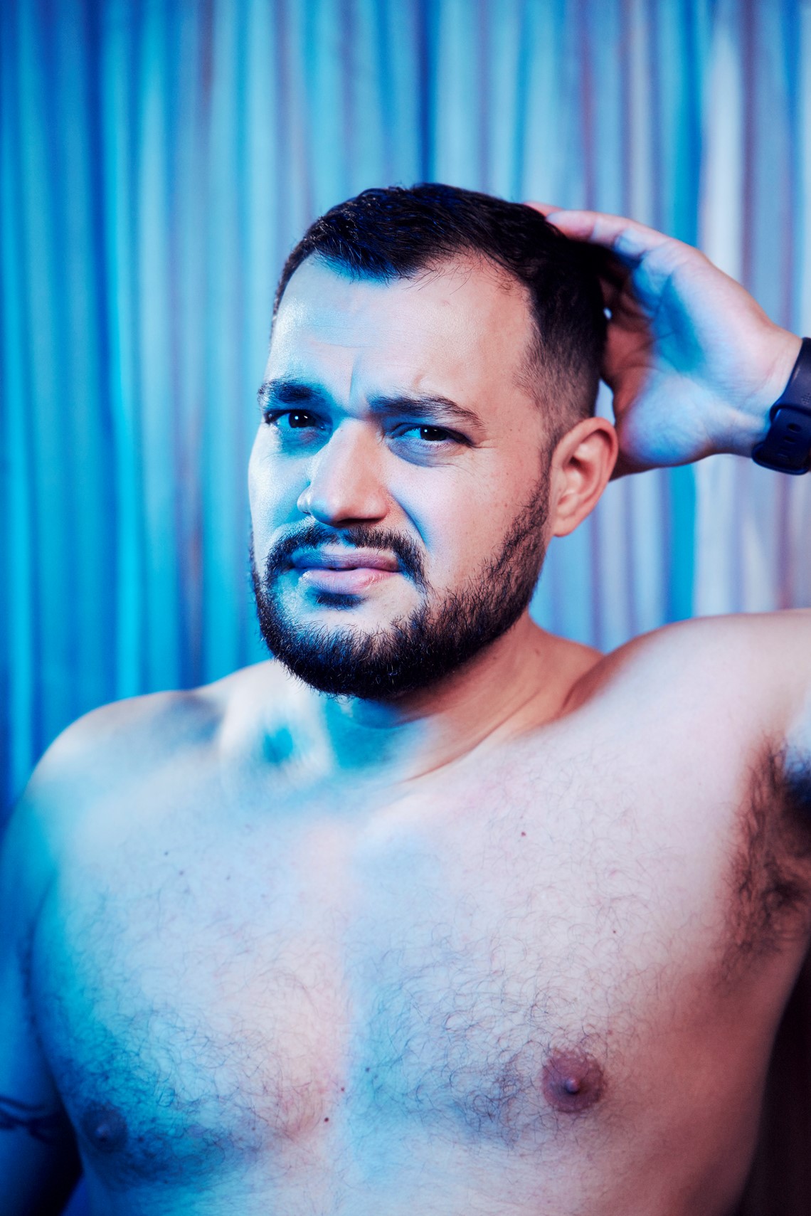 Shirtless person in deep thought