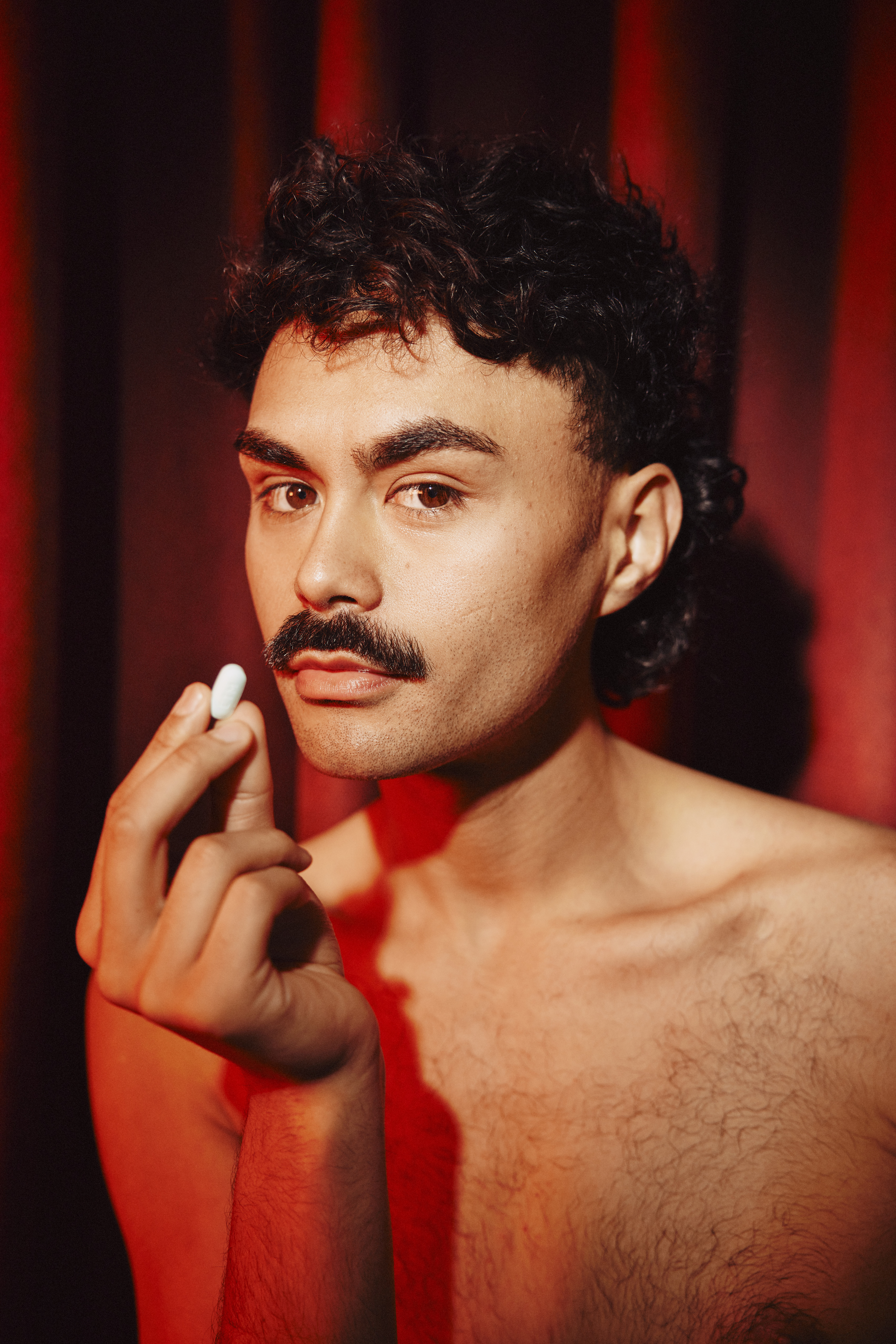 Close up of someone taking a PrEP pill